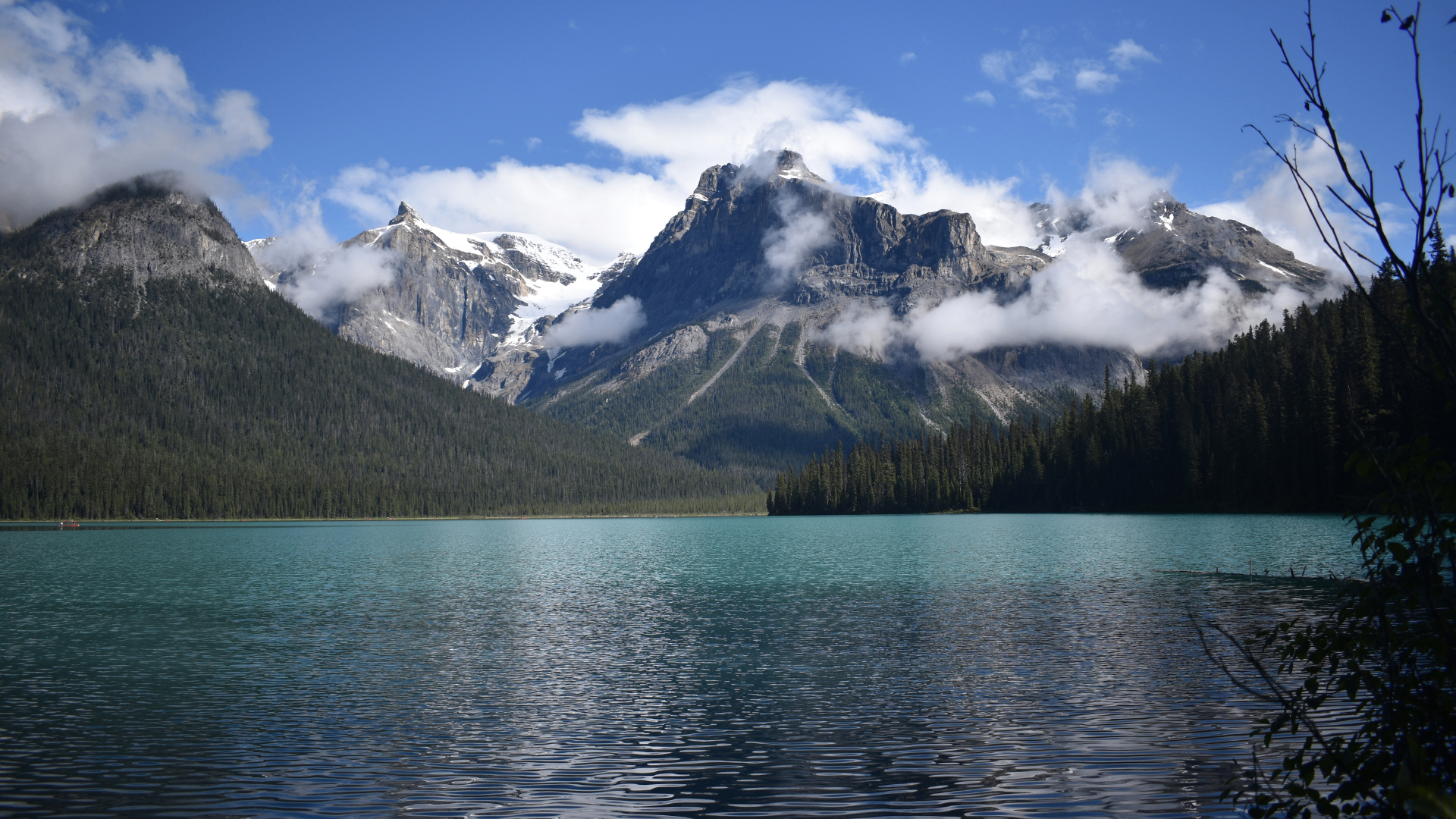 Turquoise alpine lake surrounded by forested mountains in British Columbia